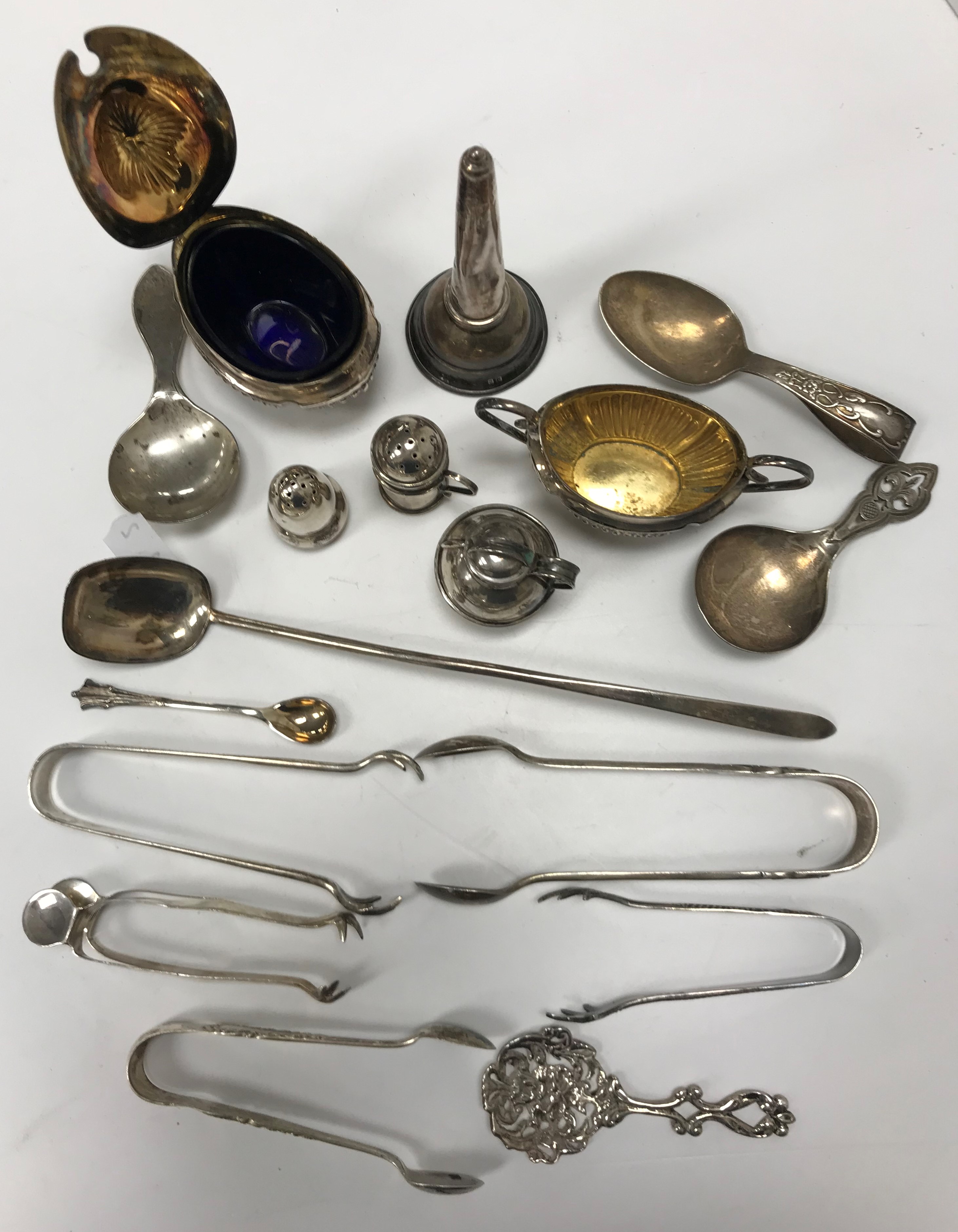 A collection of silver wares to include a miniature Guernsey creamer,