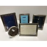 A collection of modern silver photograph frames comprising one plain rectangular examples with