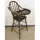 A 19th Century American child's oak spindle back high chair with tray, 43 cm wide x 102.