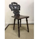 A pair of Victorian oak panel seated hall chairs with pierced medallion backs on baluster turned