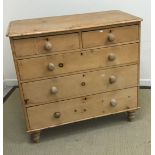 A Victorian pine chest of two short over three long graduated drawers with turned knob handles,