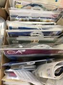 A box containing unused cross-stitch kits (19),