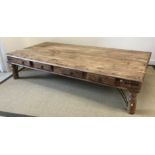 An Indian hardwood and studded coffee table of large proportions,