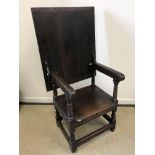 A 17th Century and later oak monk's chair, the associated three plank top with cleated ends,