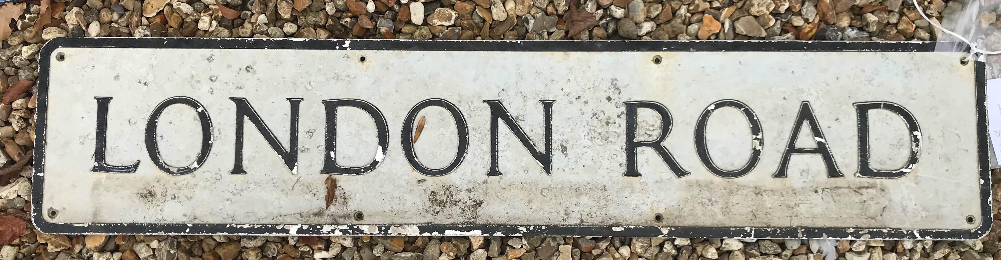 A painted metal street sign inscribed "London Road" 109 cm x 23 cm