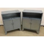 A pair of modern galvanised side cabinets, the plain top above open shelf over two cupboard doors,