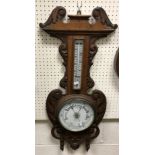 A circa 1900 carved oak cased aneroid barometer thermometer 85 cm high x 34 cm wide