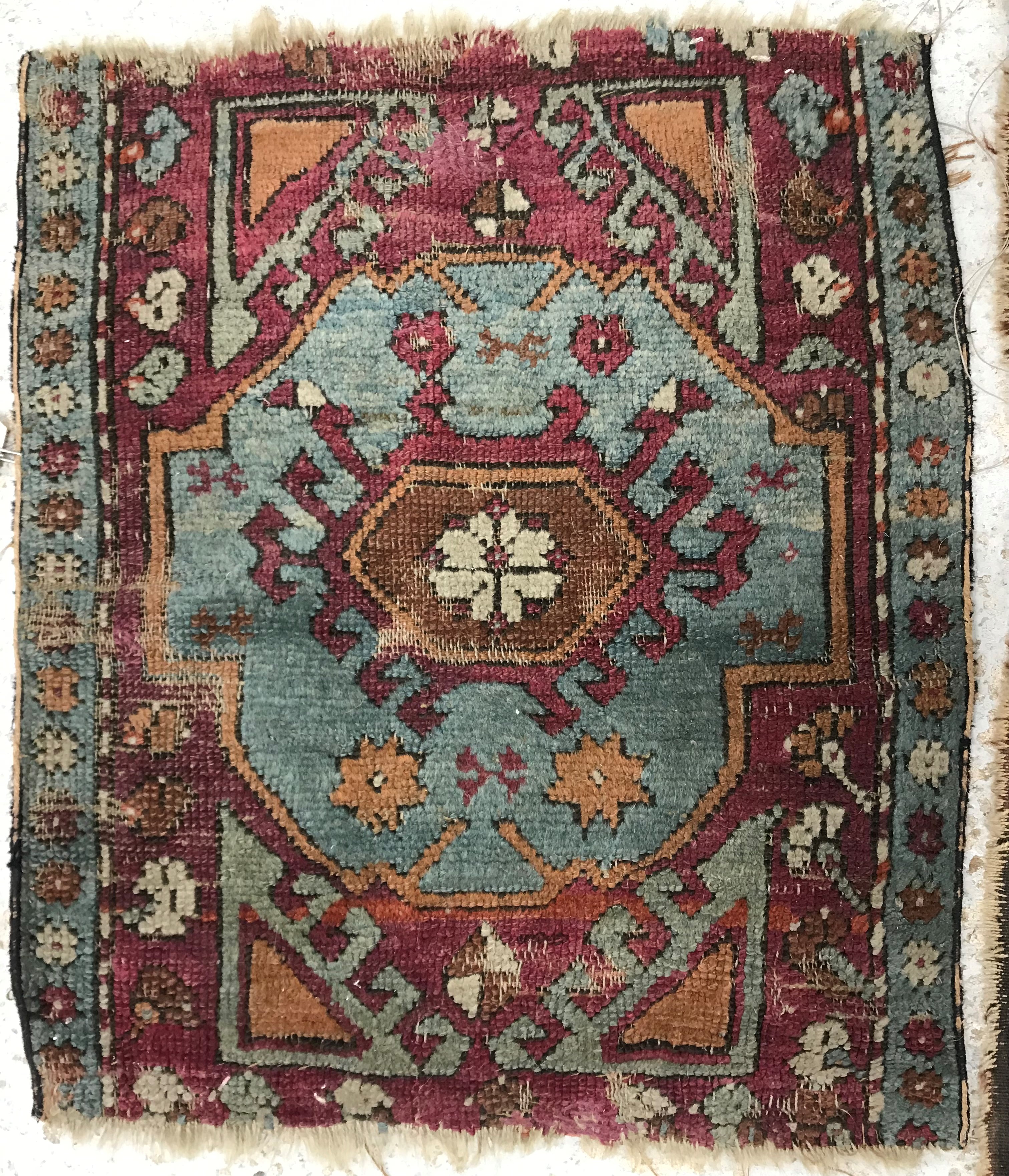 A collection of five rugs comprising a Persian floral decorated rug on purple ground,