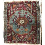 A collection of five rugs comprising a Persian floral decorated rug on purple ground,