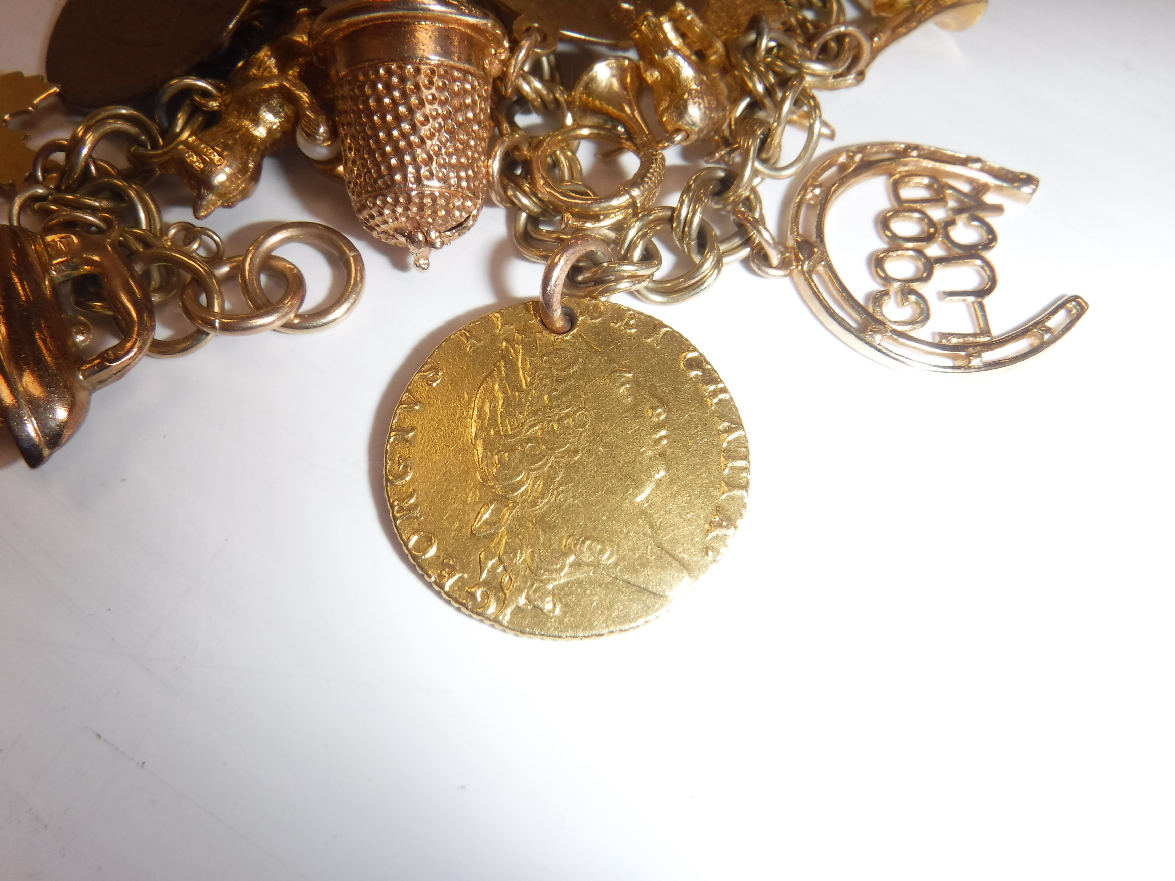 A 9 carat gold charm bracelet with various 9 carat gold and other charms, - Image 2 of 9