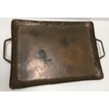 A Newlyn School copper rectangular tray by John Pearson with embossed dot decoration to the edges