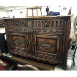 A 20th Century oak enclosed dresser in the 17th Century style,