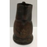 A small leather jack jug, gilt stamped "EIIR 1953", 14 cm high and a cordite carrier,