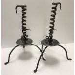 A pair of 18th Century wrought iron adjustable candlesticks of spiral form raised on three splayed