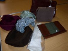 A box containing assorted vintage hats / hair pieces,