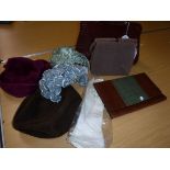 A box containing assorted vintage hats / hair pieces,