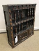 A 17th Century oak food cupboard with bog oak and holly parquetry work barber pole banding,