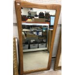 A modern rectangular wall mirror with shaped oak frame, 60 cm wide x 121 cm high,
