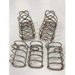 A pair of George V silver four section toast racks of love heart form (by Harrison Brothers &