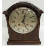 An early 20th Century mahogany cased mantel clock 32 cm high, the silvered dial inscribed "J.W.