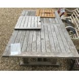 A weathered teak extending garden table of plain slatted form - unextended 207 cm long x 111 cm