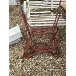 A pair of painted wrought iron bench ends with central support, a corner sink,