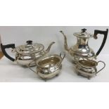 A silver four piece tea set comprising tea pot, water jug,