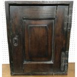 An 18th Century oak hanging wall cupboard with panelled door, 41.5 cm wide x 17 cm deep x 50.