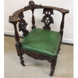 A 19th Century carved walnut corner chair with green upholstered seat,