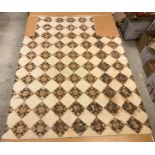 A 19th Century saw tooth and star pattern patchwork quilt (possible for a four poster bed) in cream