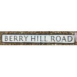 A painted metal street sign inscribed "Berry Hill Road" 122.