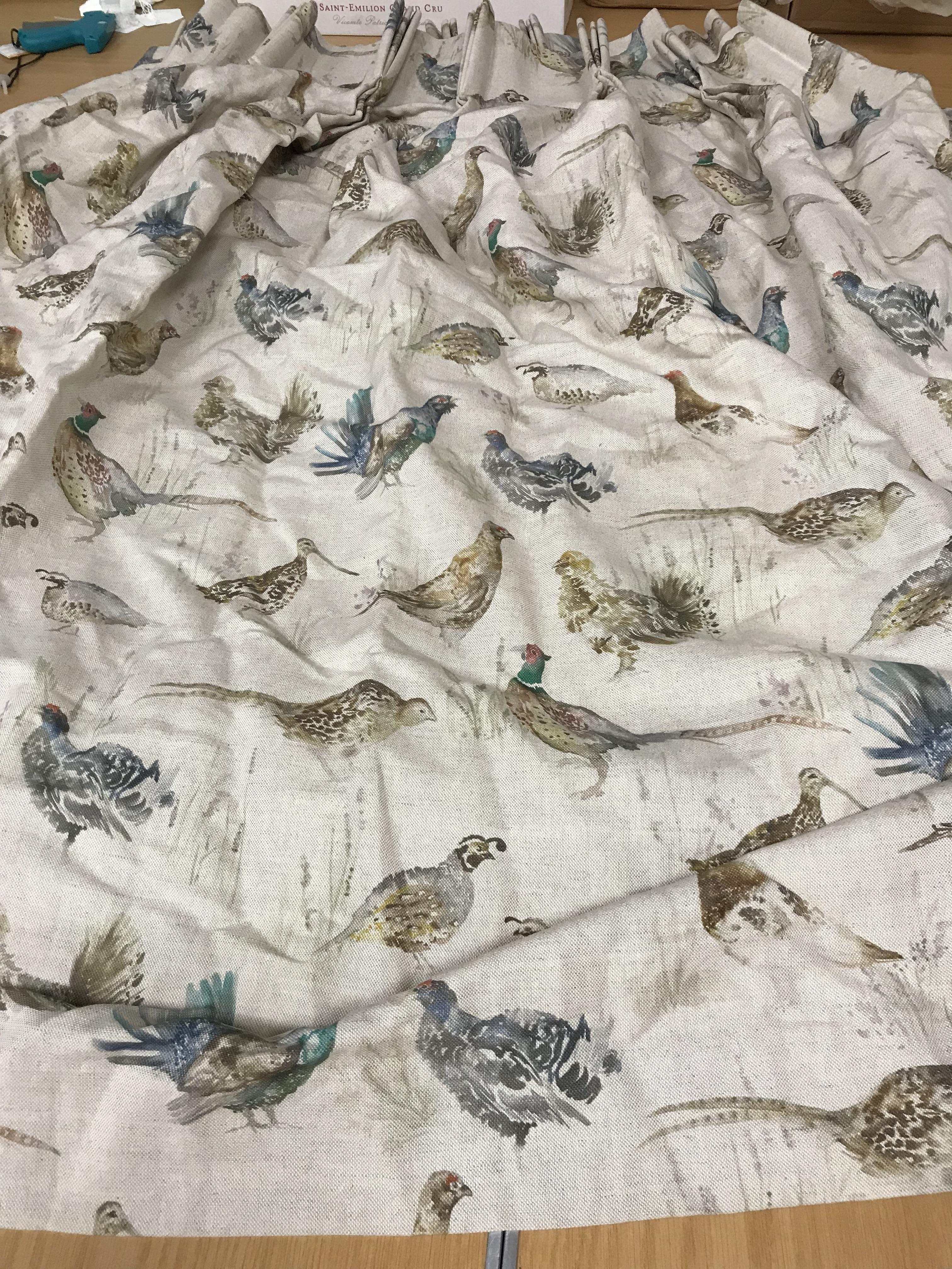 Two pairs of linen weave beige ground lined curtains decorated with various game birds, lined,