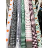 Seven rolls and part rolls of polycotton patterned fabric together with six full and part rolls of