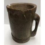 A 19th Century (or possibly earlier) carved treenware measure of mug form,