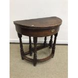 A 19th Century oak credence table of demi-lune form in the 17th Century manner,