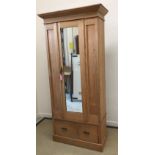 A late Victorian walnut single mirrored door wardrobe with single drawer on bracket feet 97 cm wide