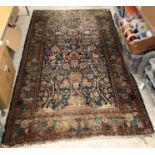 A Persian carpet, the central panel with Mihrab and Tree of Life style design on a blue ground,