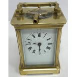 A circa 1900 French lacquered brass cased carriage clock, the enamelled dial with Roman numerals,