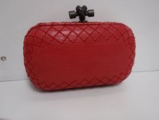 A Bottega Veneta leather knot clutch in raspberry 17 cm long x 13 cm high including handle with