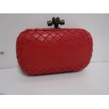 A Bottega Veneta leather knot clutch in raspberry 17 cm long x 13 cm high including handle with