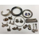 A collection of silver and white metal cufflinks, bangles, etc,