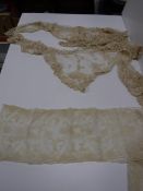 A box containing assorted lace sections to include collars, sleeves,