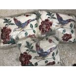 A collection of various Laura Ashley cushions in floral and pink hues,