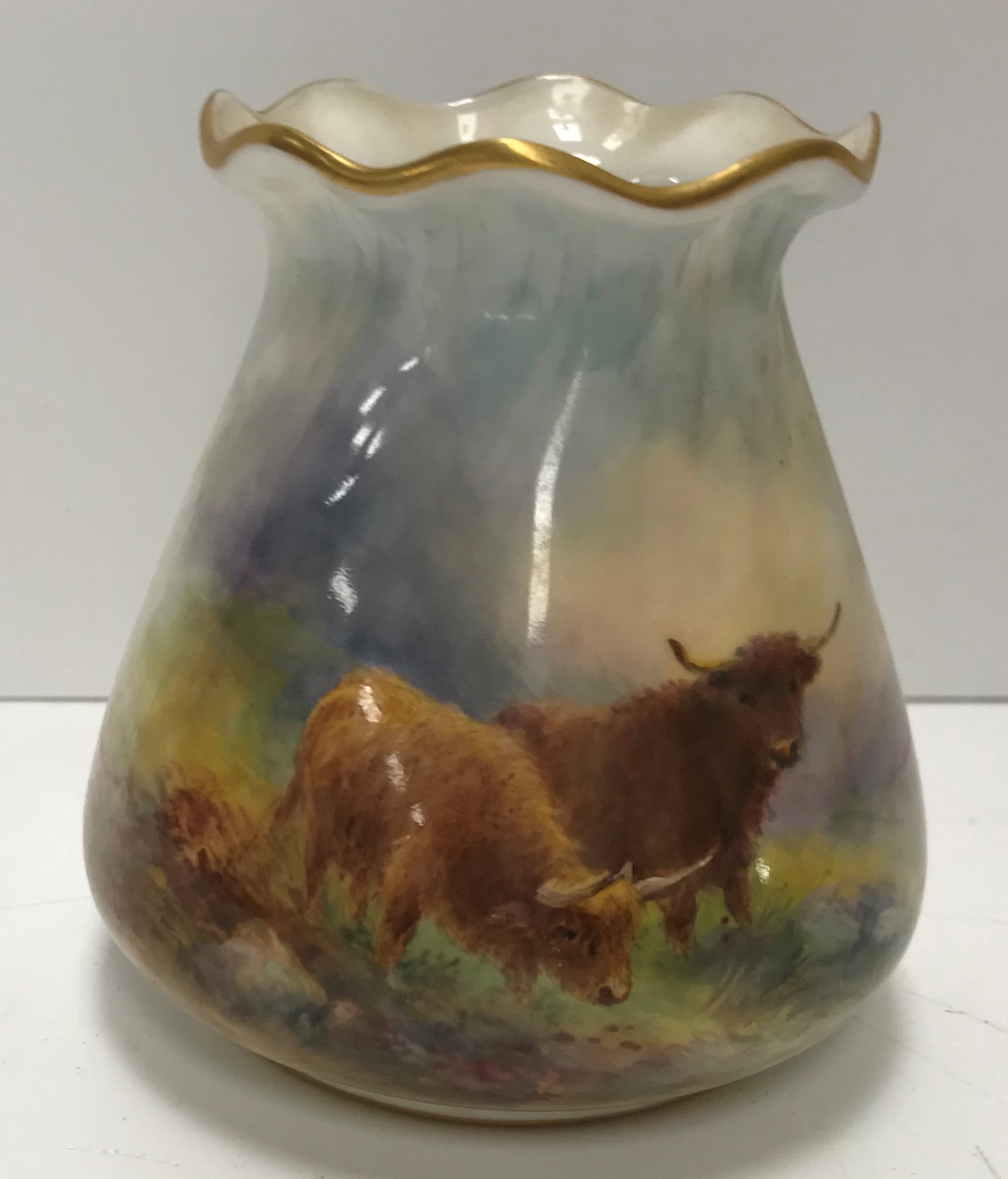 A Royal Worcester porcelain vase of bag form decorated with Highland cattle in a landscape by H