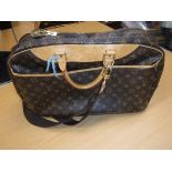 A Louis Vuitton carry all bag with shoulder strap and carry handles numbered to the interior VI0967