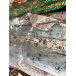 Seven part and full rolls of Christmas themed polycotton fabric together with sewing panel kits