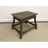 A 19th Century oak stool, the oval top with moulded edge above a plain frieze,