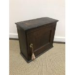 An 18th Century oak wall cupboard, the single panelled door within moulded stiles,