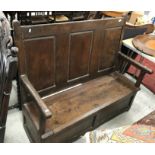 An 18th Century oak hall settle,