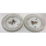 A pair of 19th Century Copenhagen floral spray decorated ribbon plates with gilt edge borders,